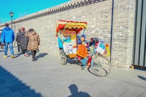 beijing.china - 24 de fevereiro de 2017.nanlouguxiang pedicab ou passeio de riquixá na parte antiga de nanlouguxiang do centro da cidade de pequim foto