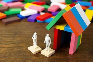 a casa de construção multicolor do domino na imagem da mesa de madeira. foto