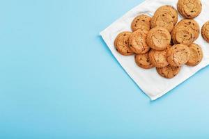 biscoitos de aveia em um fundo azul e uma vista superior de guardanapo branco foto