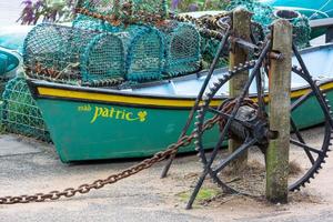 bude, cornwall, reino unido - 15 de agosto barco a remo e potes de lagosta em bude em cornwall em 15 de agosto de 2013 foto