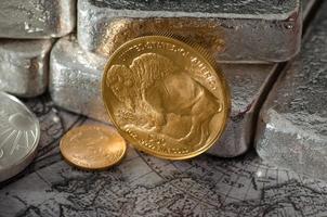 moeda de búfalo de ouro dos estados unidos com barras de prata e mapa