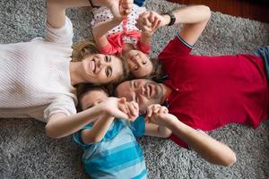 família feliz deitada no chão foto