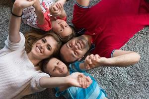 família feliz deitada no chão foto