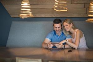 casal usando tablet em casa foto