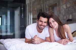 casal relaxa e se diverte na cama foto