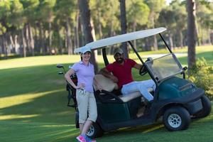 casal de buggy no campo de golfe foto