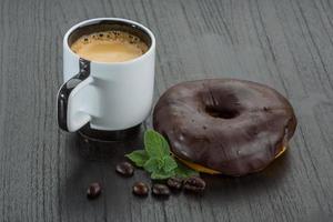 café com donuts em fundo de madeira foto