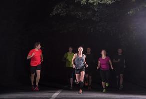 equipe de corredores no treinamento noturno foto