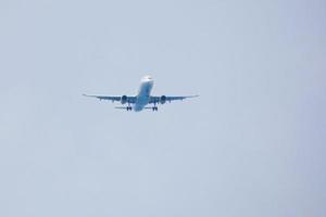 aeronaves comerciais voando sob céu azul e chegando ao aeroporto foto