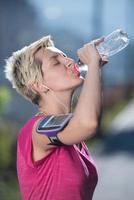 mulher bebendo água depois de correr foto