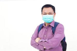 homem de negócios asiáticos usa camisa roxa e máscara facial médica para proteger seu sistema respiratório do covid-19 coronavírus-19 ou patógeno no estilo de vida de saúde. foto