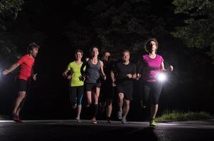 equipe de corredores no treinamento noturno foto