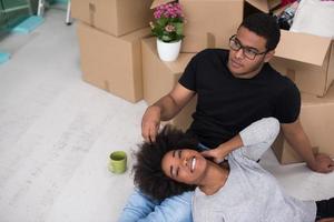 casal americano africano relaxando em casa nova foto