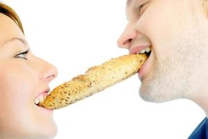 casal feliz comendo croissant foto