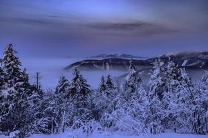 montanhas inversas da noite de inverno em beskydy foto