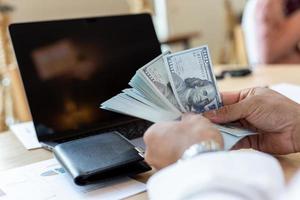 empresário lida com dinheiro no trabalho para analisar demonstrações financeiras foto