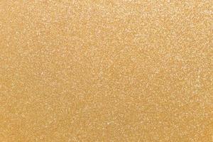 sem costura padrão, fundo de glitter dourado. postura plana brilhante com espaço de cópia para seus projetos. pano de fundo dourado na moda foto