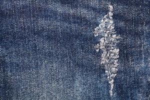 jeans velhos rasgados usam como pano de fundo foto