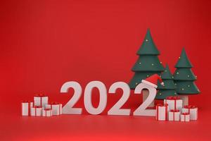 fonte 2022, chapéu de papai noel, caixa de presente, árvore de natal no natal e ano novo em fundo vermelho foto