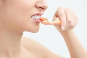 mulher em atendimento odontológico e higiene bucal com escova de dentes foto