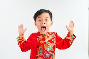 linda criança asiática é surpresa e tão feliz com isso em ao dai em fundo branco isolado foto