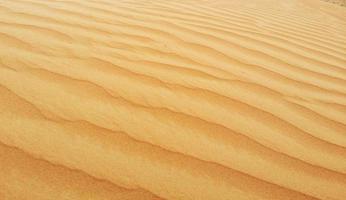 ondas de textura de areia. dunas do deserto. paisagem por do sol de dunas do deserto. foto