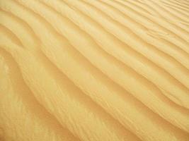 ondas de textura de areia. dunas do deserto. paisagem por do sol de dunas do deserto. foto