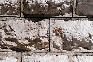 textura de parede de pedra velha, superfície de parede de tijolo retrô resistida, superfície de alvenaria texturizada, fundo áspero grunge. foto