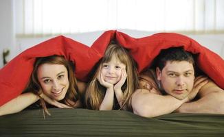 família feliz relaxando na cama foto