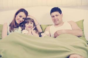 família feliz relaxando na cama foto