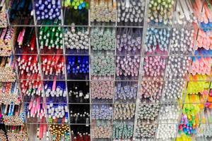 canetas coloridas, lápis, marcadores na prateleira na papelaria foto