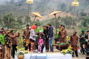 dieng, indonésia - 1 de agosto de 2015. festival de cultura de dieng, turistas seguem a procissão de dreadlocks durante o evento do festival de cultura de dieng em dieng, distrito de banjarnegara, java central foto