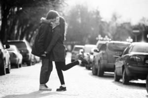 cara e a garota se beijando na rua da cidade foto