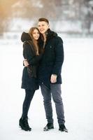 casal posando em um parque nevado foto