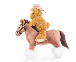 ursinho de pelúcia cowboy andando a cavalo foto