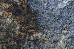 fundo de textura de rocha de granito cinza cru. fragmento de parede de pedra natural foto