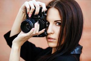 linda fotógrafa feminina posando com câmera foto