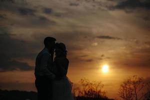 silhueta de casal de noivos em campo foto