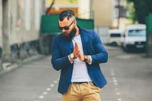 homem barbudo elegante caminha pela cidade foto