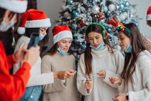 jovens multiétnicas comemorando a véspera de ano novo segurando estrelinhas foto