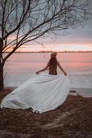 linda garota de maiô na margem de um lago congelado foto