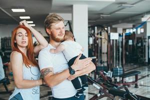 jovem família com menino no ginásio foto