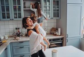 família feliz se divertindo na cozinha foto