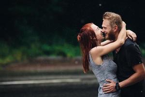 lindo casal abraçando na chuva foto