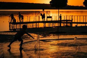 garotinho está brincando com uma fonte foto