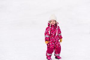menina se divertindo no dia de inverno nevado foto