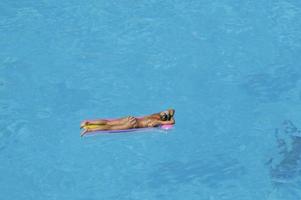 mulher relaxa na piscina foto