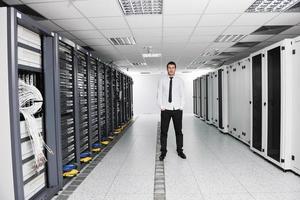 jovem engenheiro de TI na sala do servidor do datacenter foto