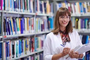 o aluno usa um notebook e uma biblioteca escolar foto