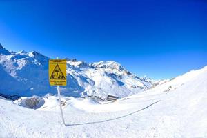 placa de sinal em altas montanhas sob neve no inverno foto